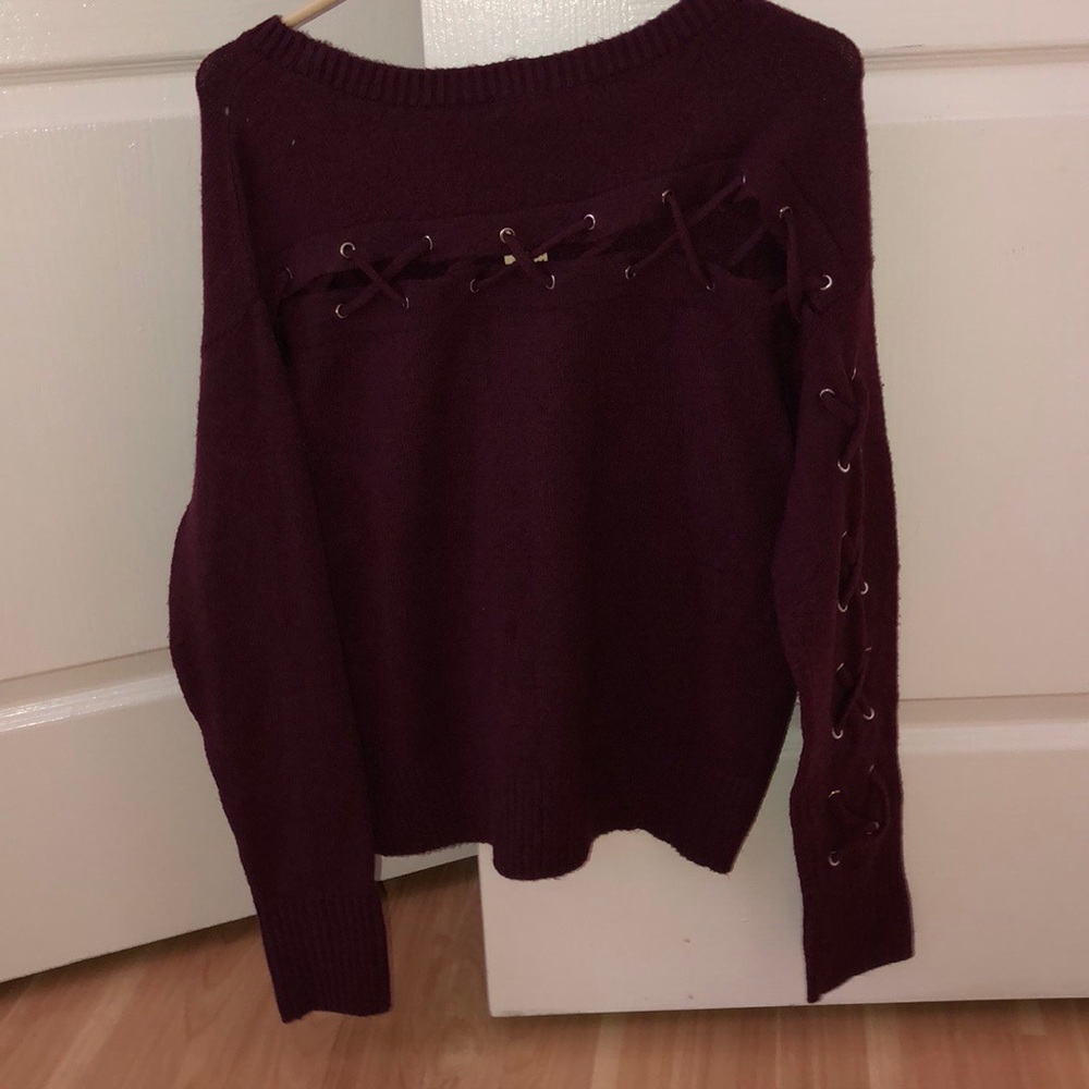 woman’s maroon long sleeve shirt
